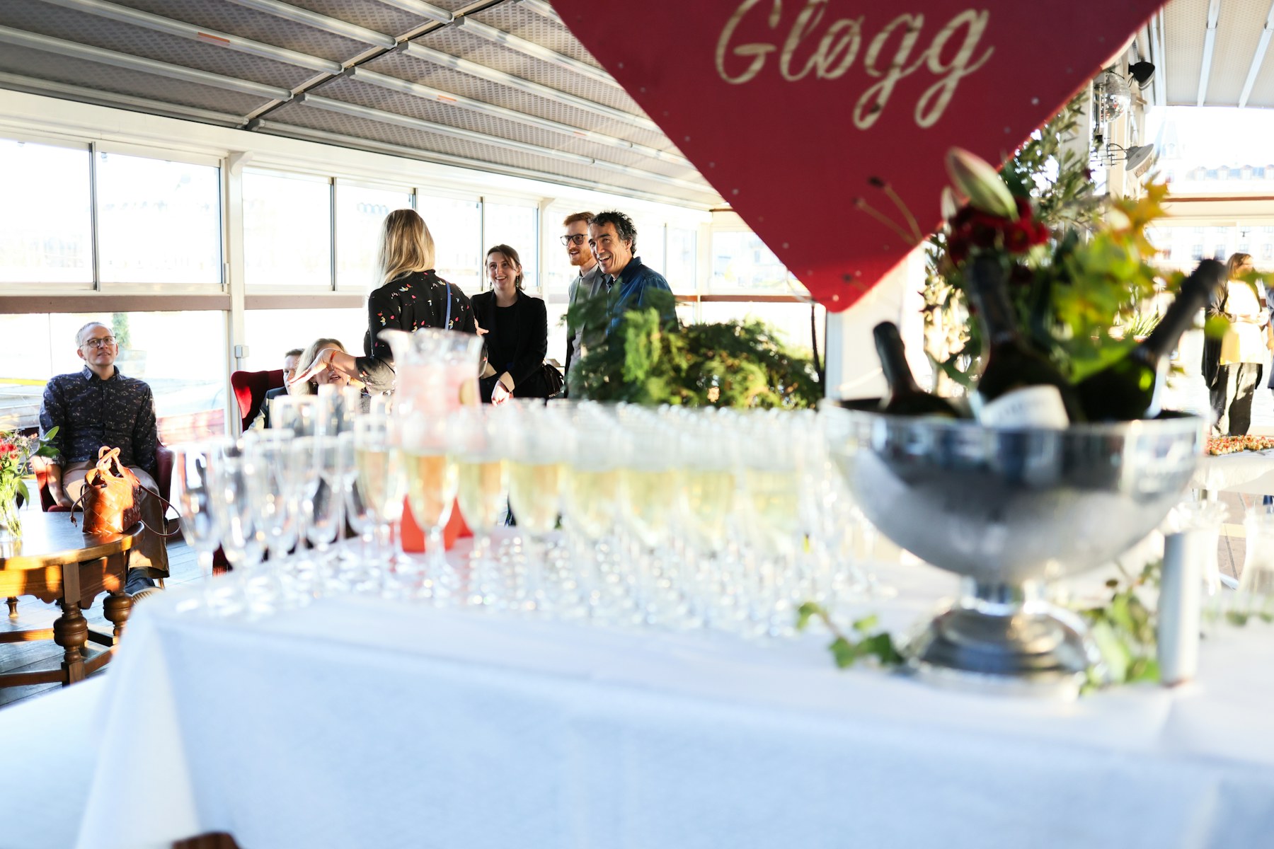 Invités réunis autour d’une réception et de coupes de champagne